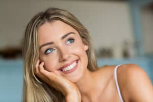 Smiling Woman Thinking about her Alternatives to Teeth Whitening